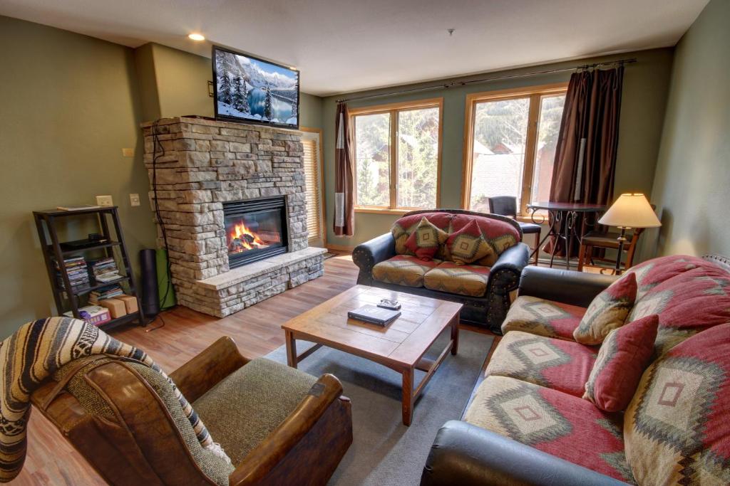 a living room with a couch and a fireplace at Gateway Lodge 5030 by SummitCove Lodging in Colorado in Keystone