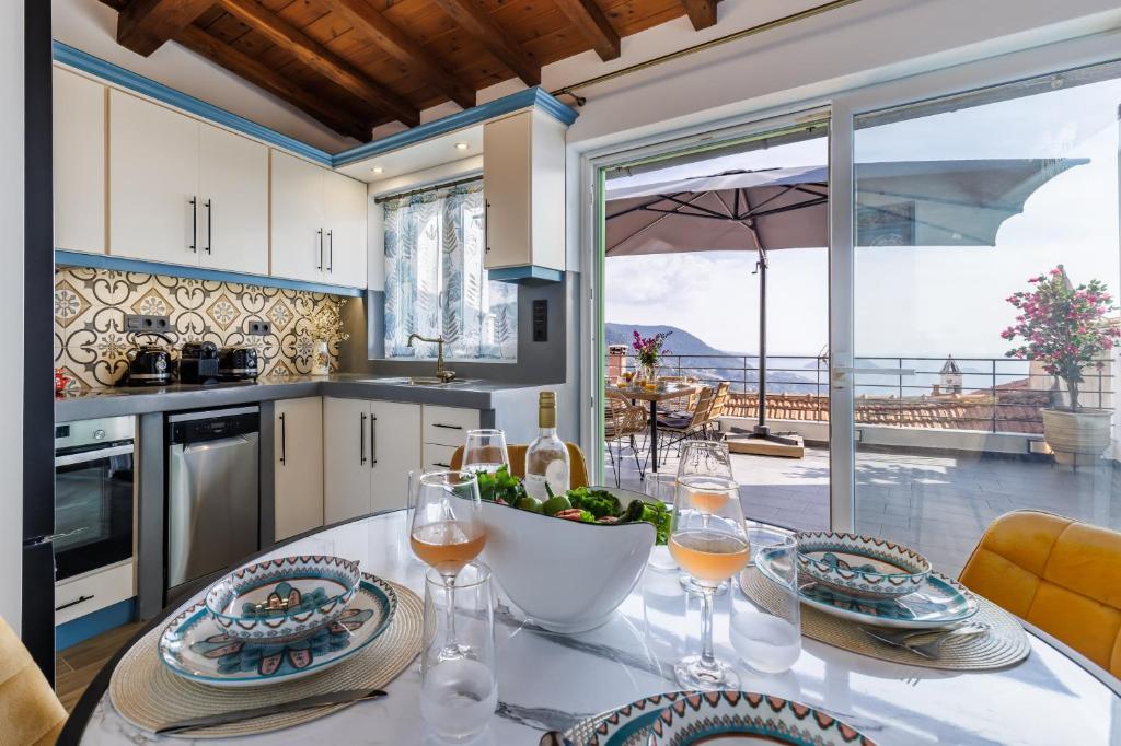 a kitchen with a table with glasses of wine at Larimis House in Loutraki