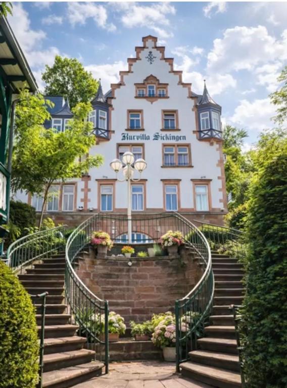 a building with stairs in front of it at Kurvilla Apartments in Landstuhl