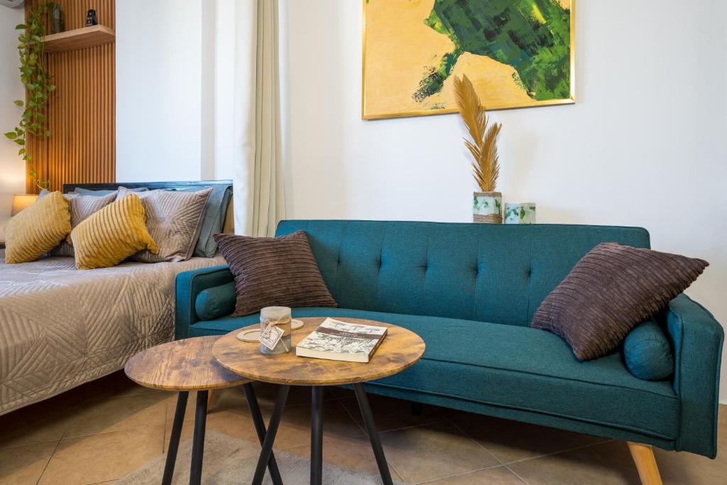 a living room with a blue couch and a table at ILIRIA Apartment in Durrës