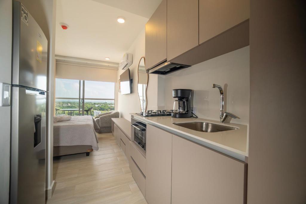 a kitchen with a sink and a counter top at Refugio Del Mar Bello Horizonte Playa Dormida in Santa Marta