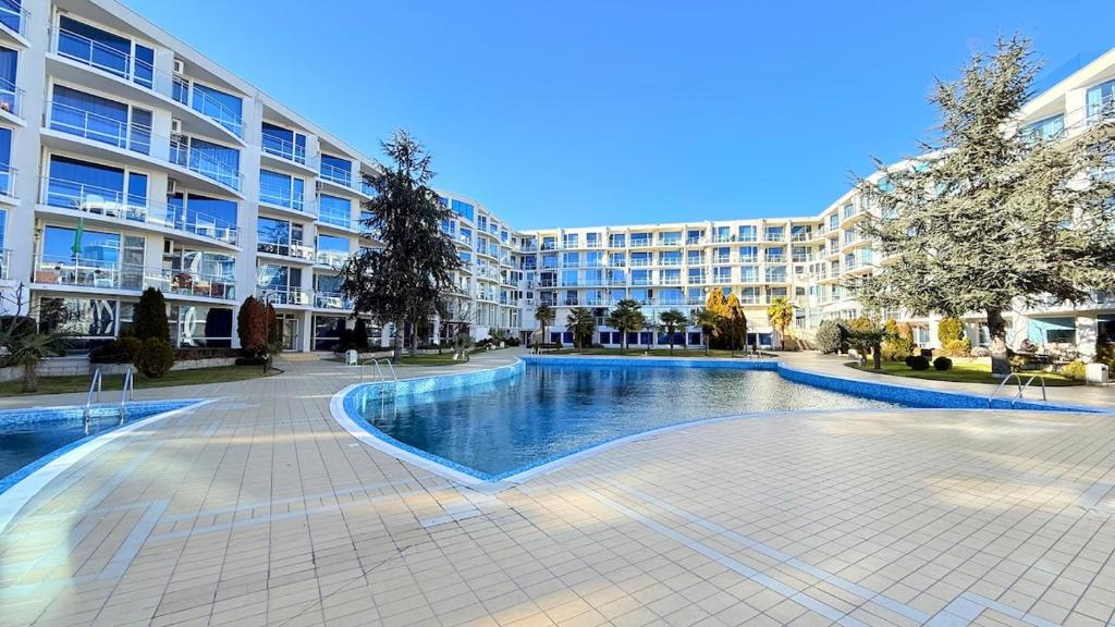 a large apartment building with a large swimming pool at Atlantis Resort Nikol in Burgas