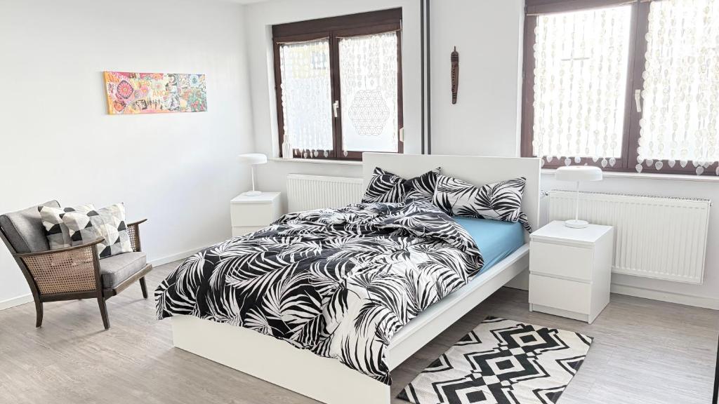 a bedroom with a bed with a black and white comforter at Gästezimmer Kirrlach in Waghäusel
