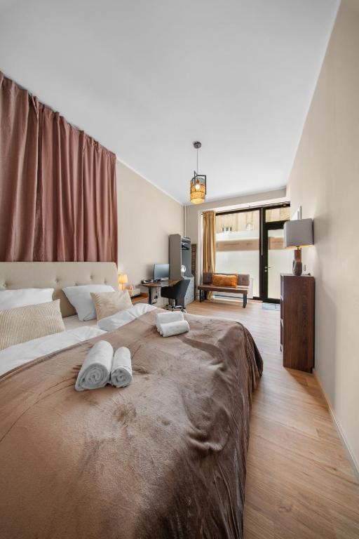a bedroom with a large bed with two shoes on it at Loftly Modersohnstr nähe East Side Gallery nähe Uber Arena in Berlin
