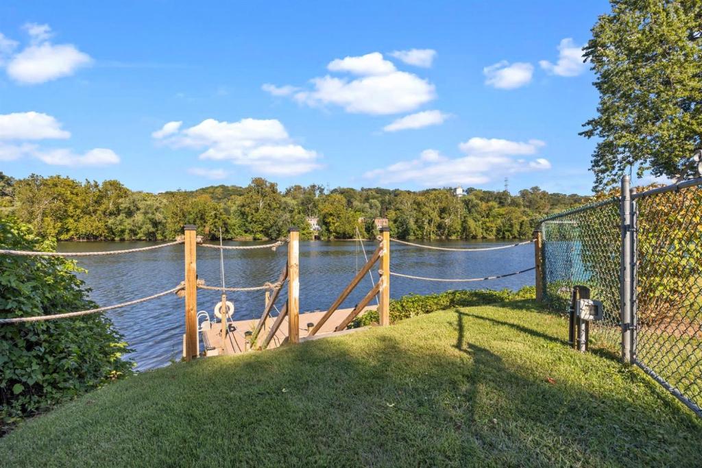 a bridge over a river with a net on it at Kayaks & River Access Easy Parking Beautiful in Gladwyne