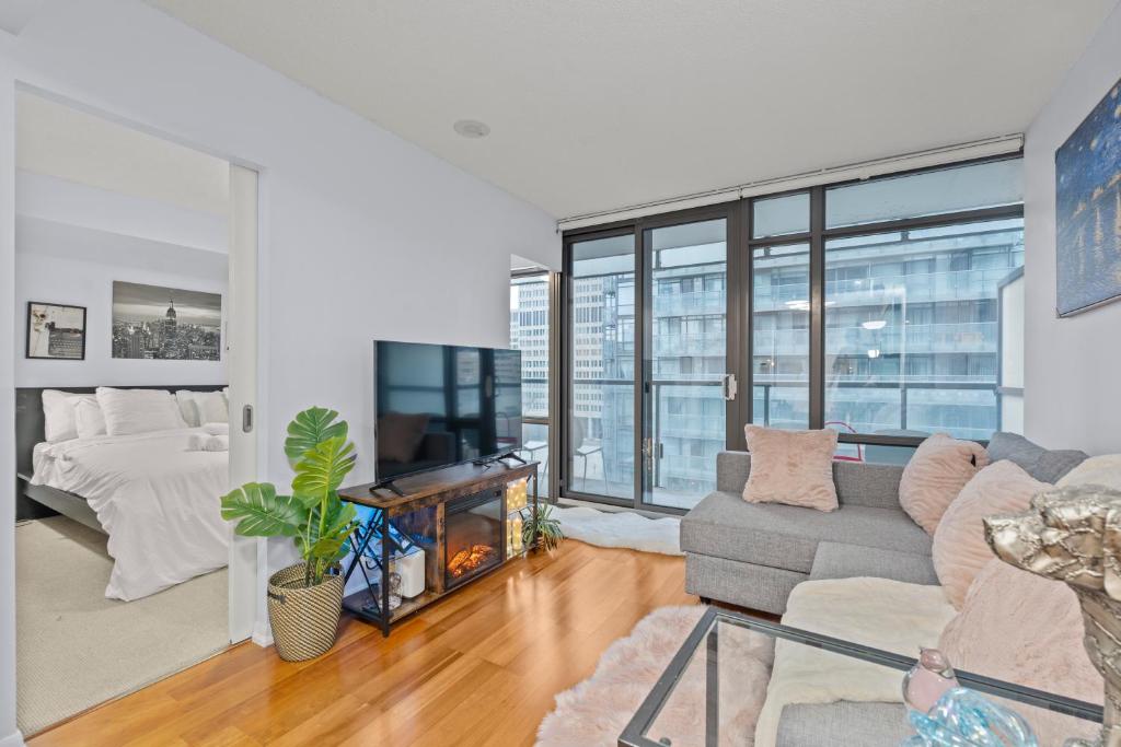 a living room with a couch and a fireplace at Stylish 2BR Downtown Sanctuary - Free Parking in Toronto