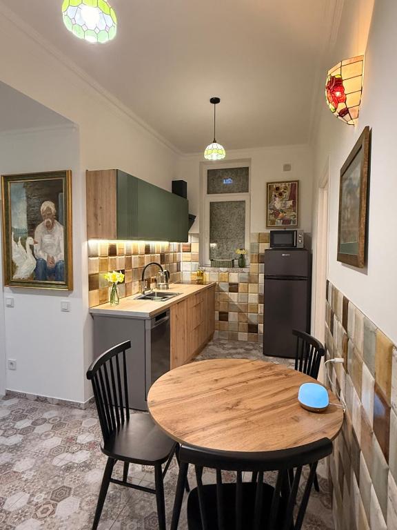 a kitchen with a wooden table and chairs and a sink at Федорцьо in Mukacheve