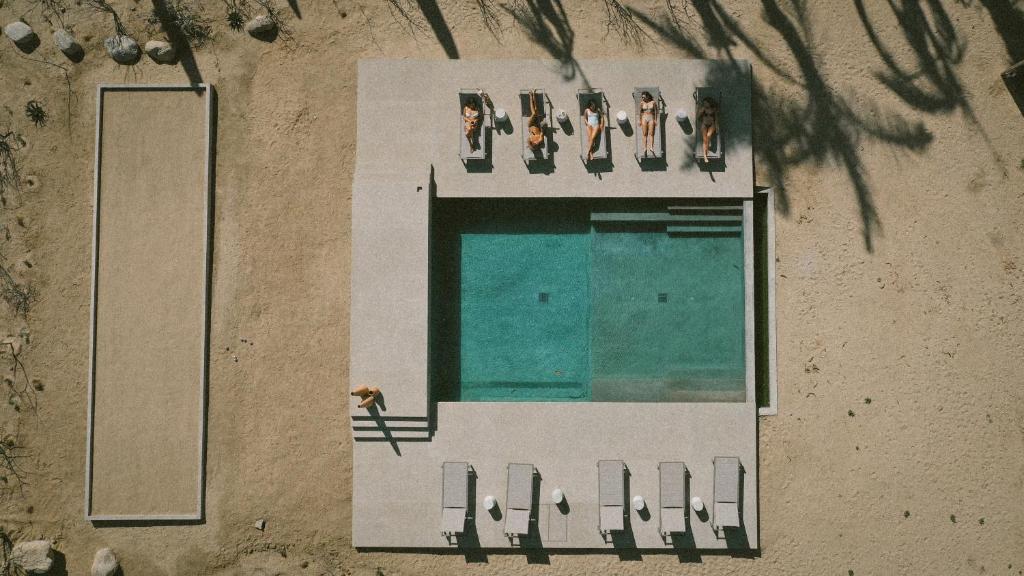 an overhead view of a swimming pool with people sitting at Salara Boutique Hotel & Villas Todos Santos in Todos Santos