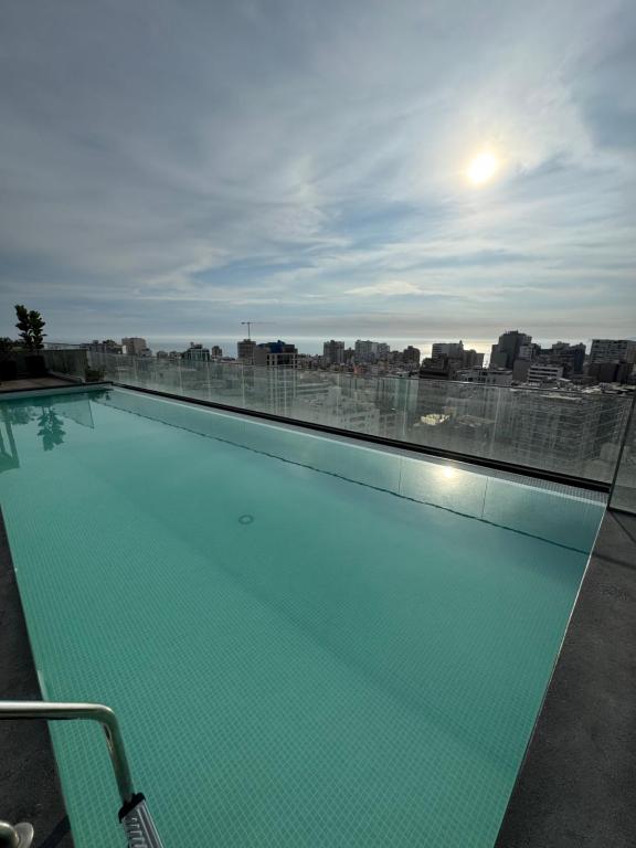 a swimming pool on the roof of a building at Miraflores Loft Piscina in Lima