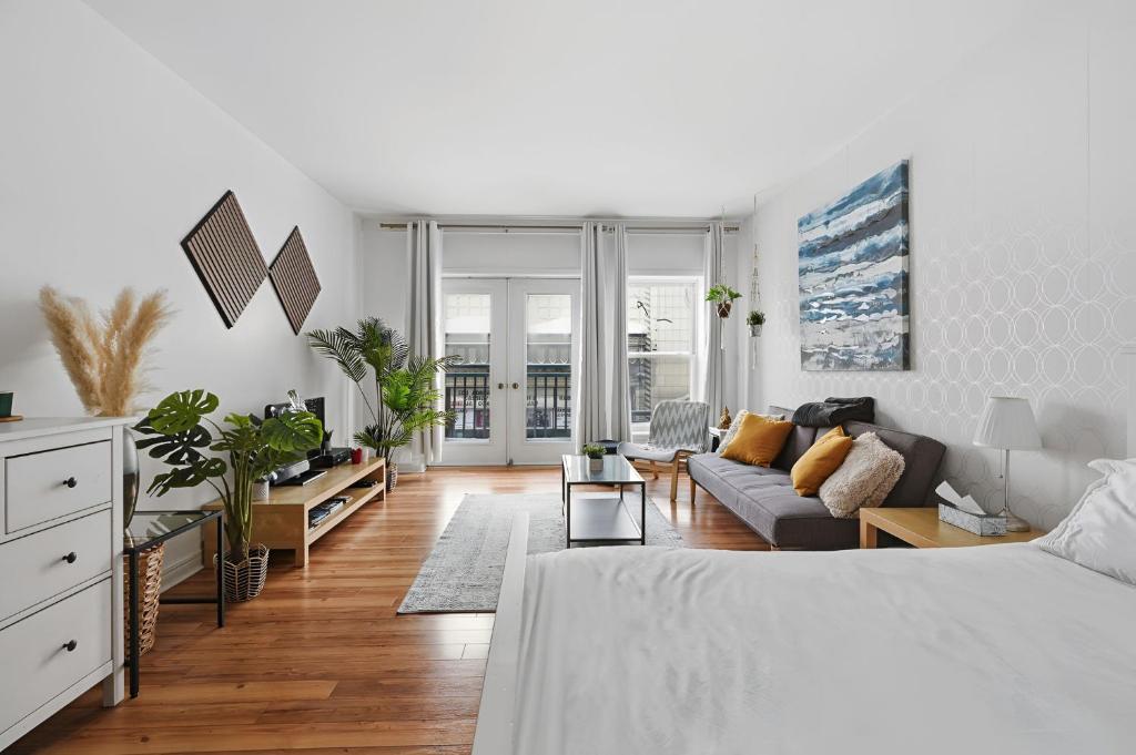 a white room with a bed and a couch at Condo St-Roch in Quebec City