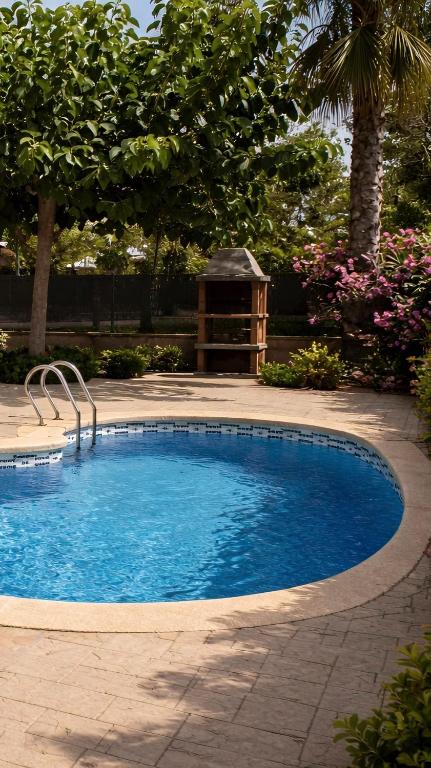 a large swimming pool in a yard with a bench at Casa Amor - "Pet Friendly - Piscina Privada - Playa - BBQ - Parking - Delta de l'Ebre - Riumar" in Riumar