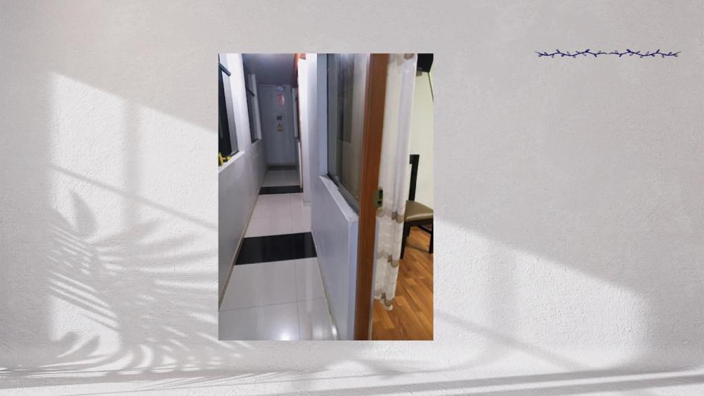 a hallway with a mirror in a room at Hotel Valparaiso in San Antonio