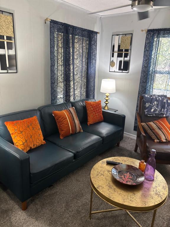 a living room with a black couch and a table at Urban Oasis in Jacksonville