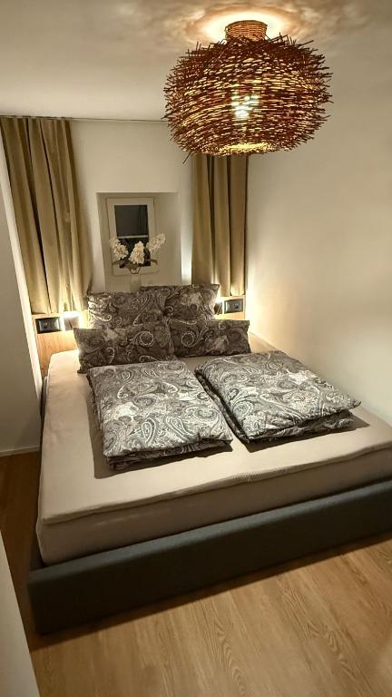 a bedroom with a large bed with a chandelier at Gottlieber Rausch in Gottlieben