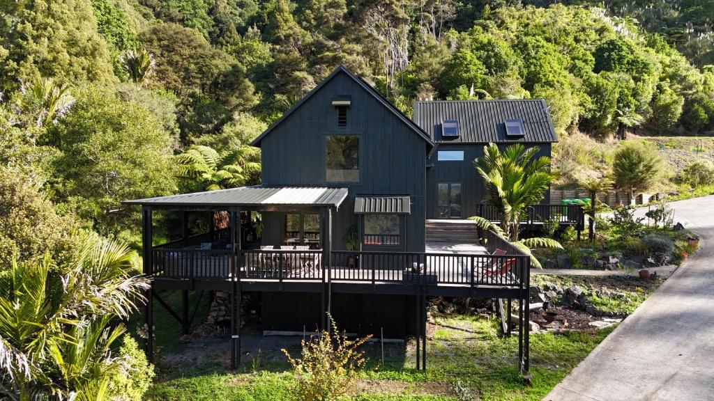 a house on the side of a mountain at Matakana Retreat - Luxury Off Grid Lodge in Nature in Matakana