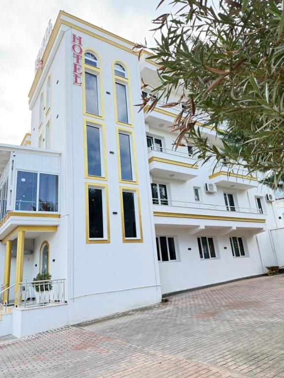 a white building with a large window at Hotel corner in Bërzhitë