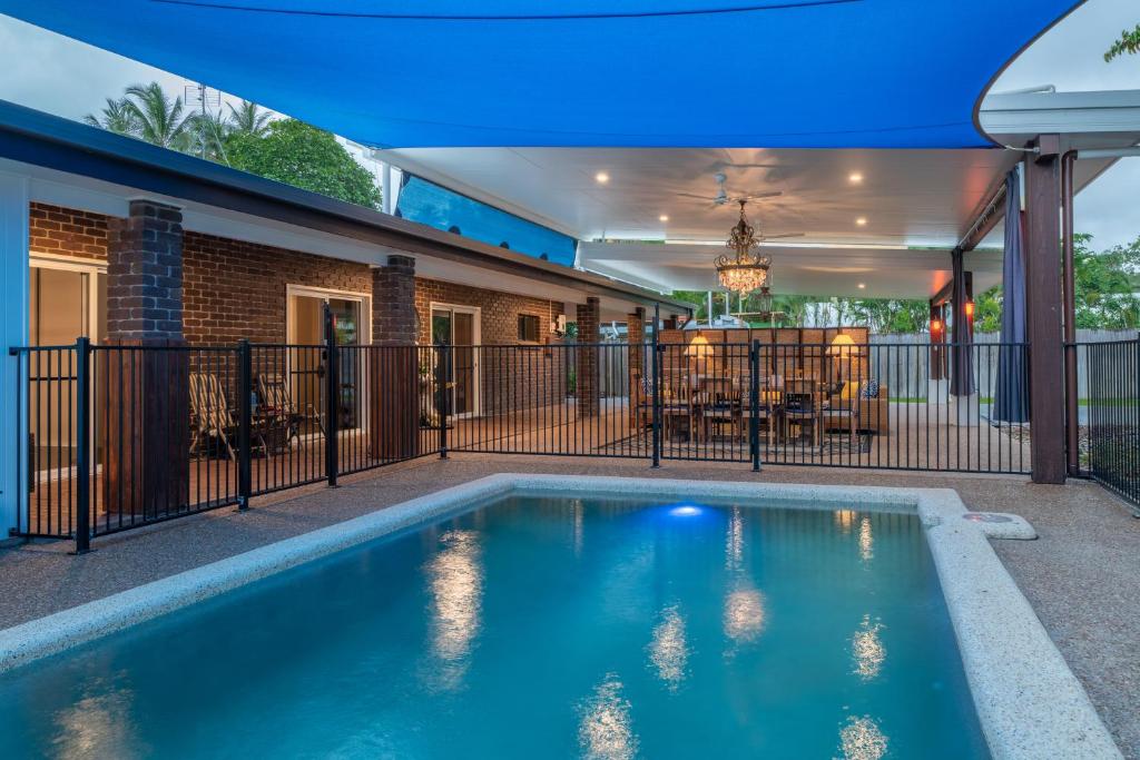 a swimming pool in the backyard of a house at Wonga Belle Beach House in Wonga