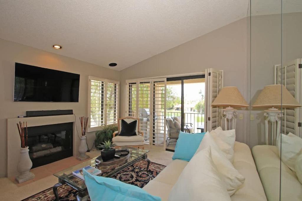 a living room with a white couch and a fireplace at Balcony-Views-Country Club Living-VV667 in Palm Desert