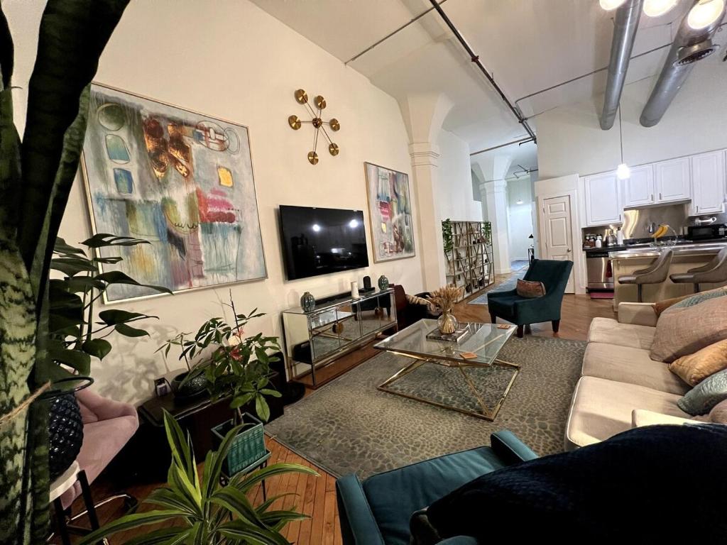 a living room with a couch and a table at Stylish Loft, Walk to WORLD CUP! in Atlanta