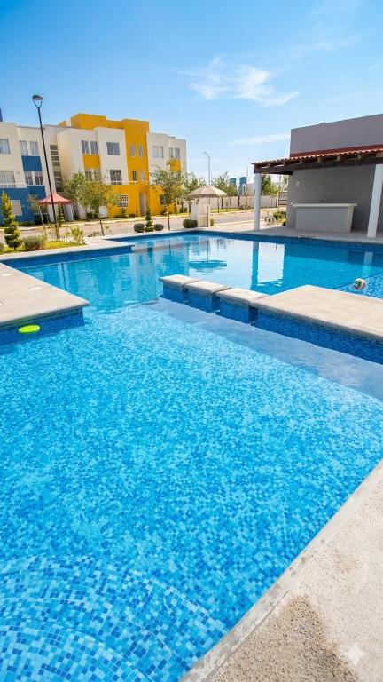 a large swimming pool with blue water at DePA DRAGON in Tizayuca