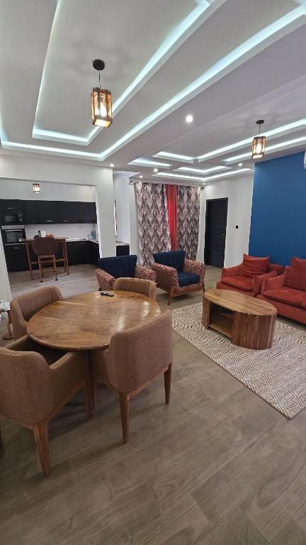 a living room with a table and a couch at Ouakam Monument de la Renaissance 2 in Dakar