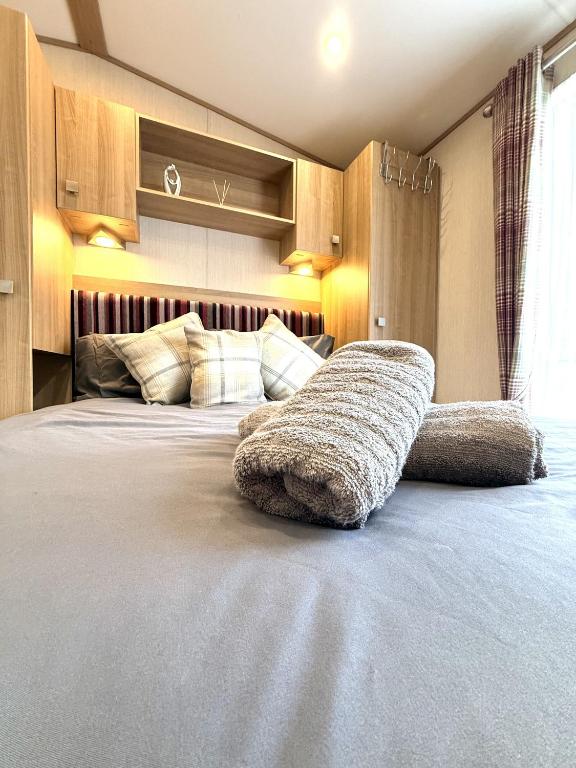 a bedroom with a large bed with a large sqor at The Haven in Filey
