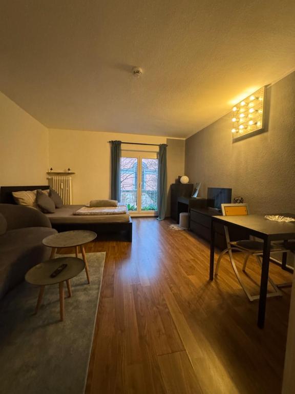 a living room with a couch and a table at Central CityNest Studio No 8 in Wuppertal