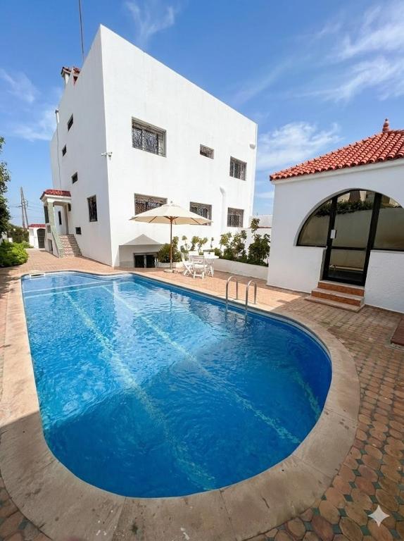a large swimming pool in front of a house at Palace with Private Pool in Tamaris