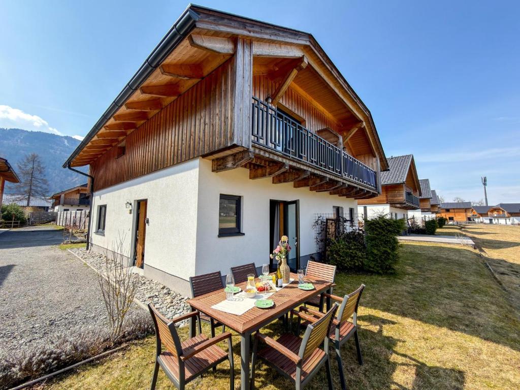 a wooden table in front of a house at Rattendorf 15A in Rattendorf