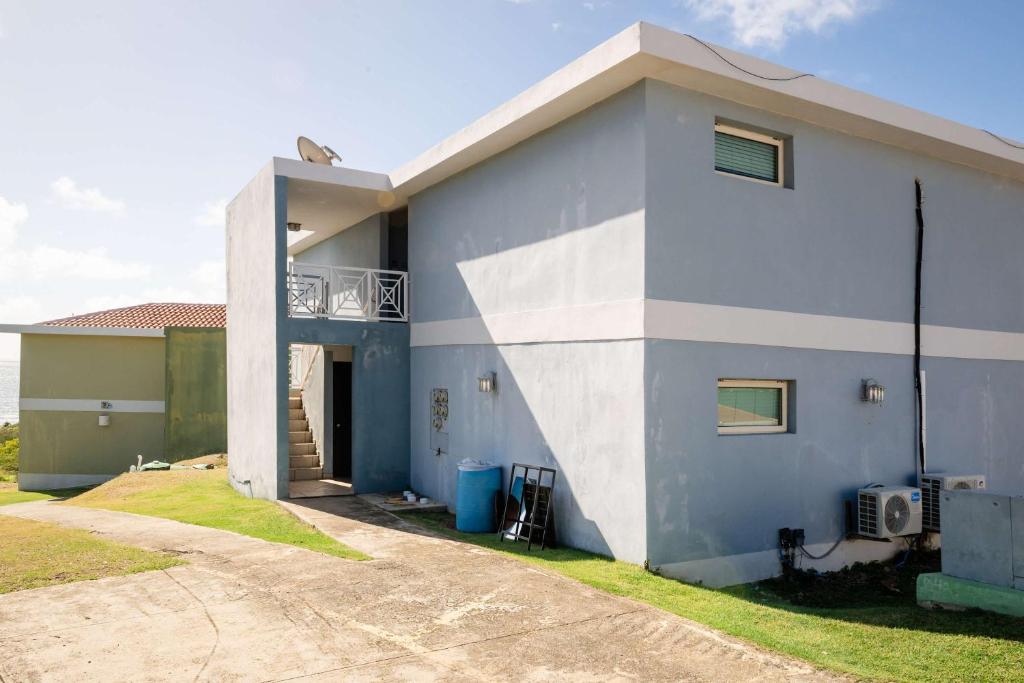 a blue and white house with a driveway at Villa Costera 904 | Island Escapade | Culebra in Culebra