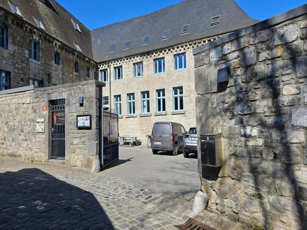 a stone building with a van parked in front of it at Spacious Durbuy Apartment for 6 in Durbuy