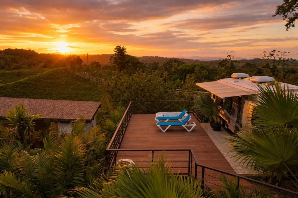 a deck with a lounge chair on top of a house at Airstream Stay Private Jacuzzi & Volcano View in Monterrey