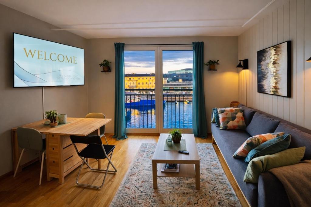 a living room with a couch and a table at Trondheim Fjord Suites Self Checkin And Out in Trondheim