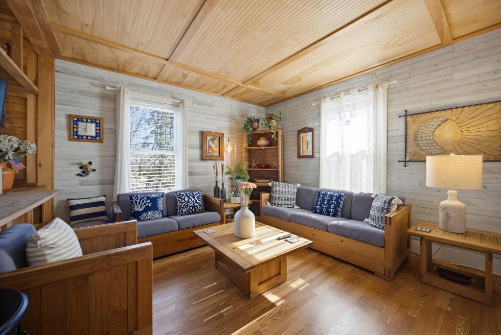 a living room with a couch and a table at Retreat near Beaches in Gloucester