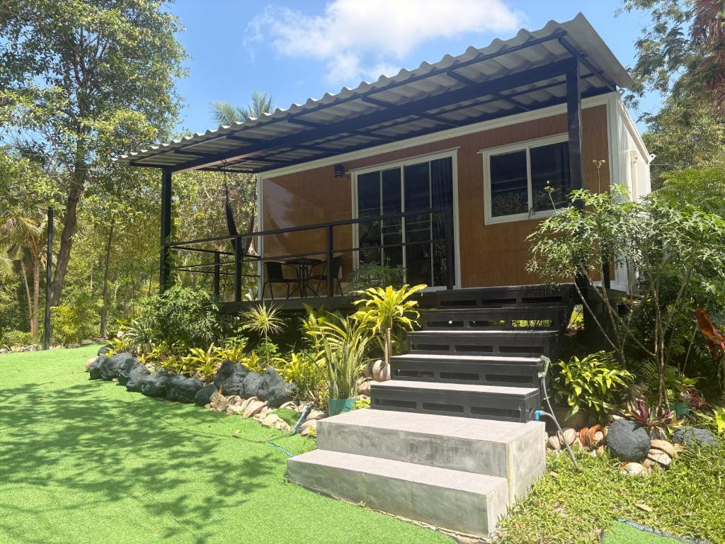 a house with stairs leading up to it at Moon Jungle Bungalows in Ban Madua Wan