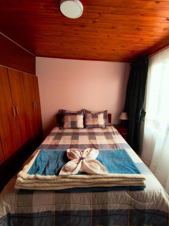 a bedroom with a bed with a bow on it at Luma Dorada in Bogotá