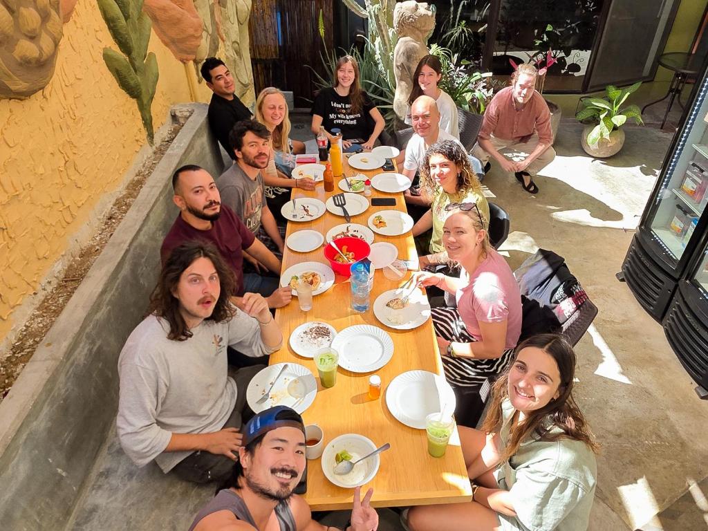 a group of people sitting at a table eating at Leveli Coliving & Hostel Oaxaca in Oaxaca City