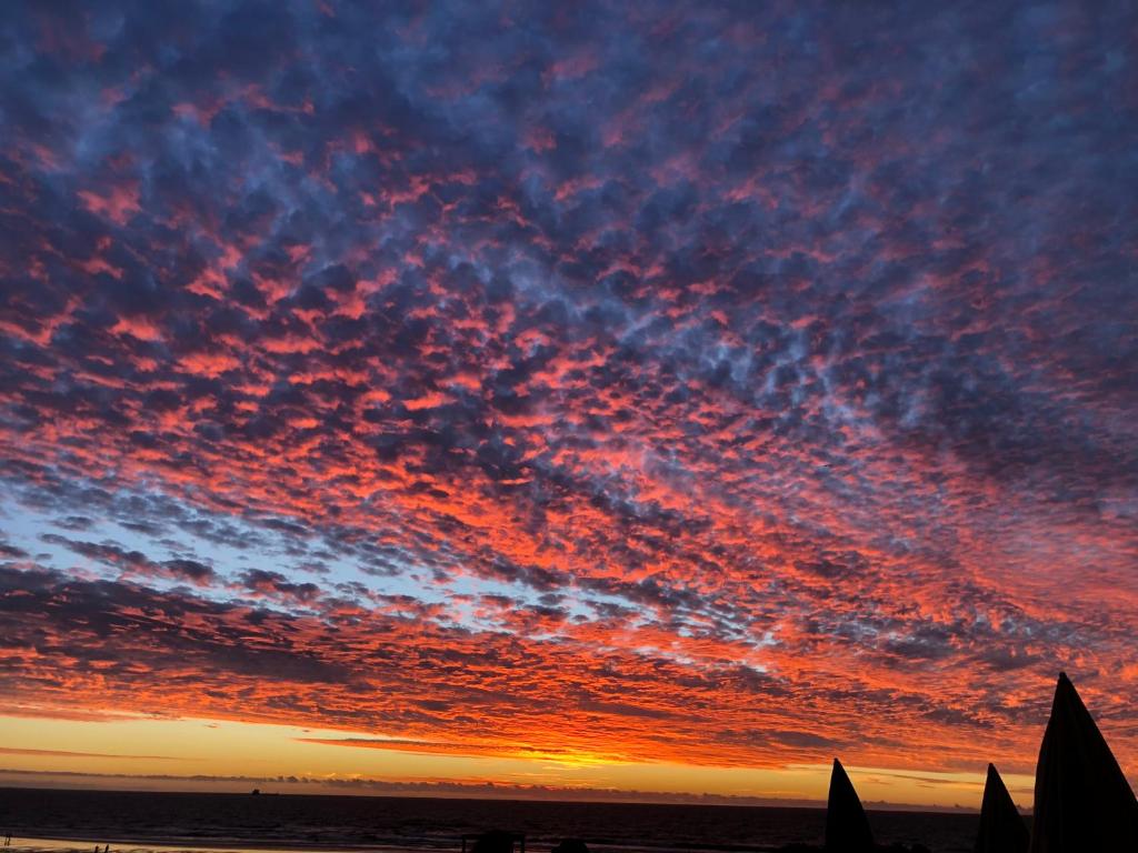 a sunset with colorful clouds in the sky at Anza surf spot in Agadir