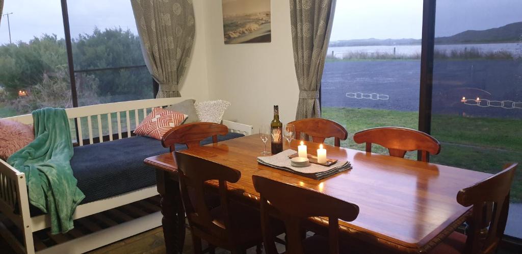 a dining room with a table and a couch at Riverview Coastal Retreat Sleeps 6 Walk to Beach Great Ocean Road in Peterborough