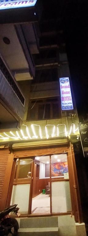 a sign above a door of a restaurant at night at Second Home Hotel in Kathmandu
