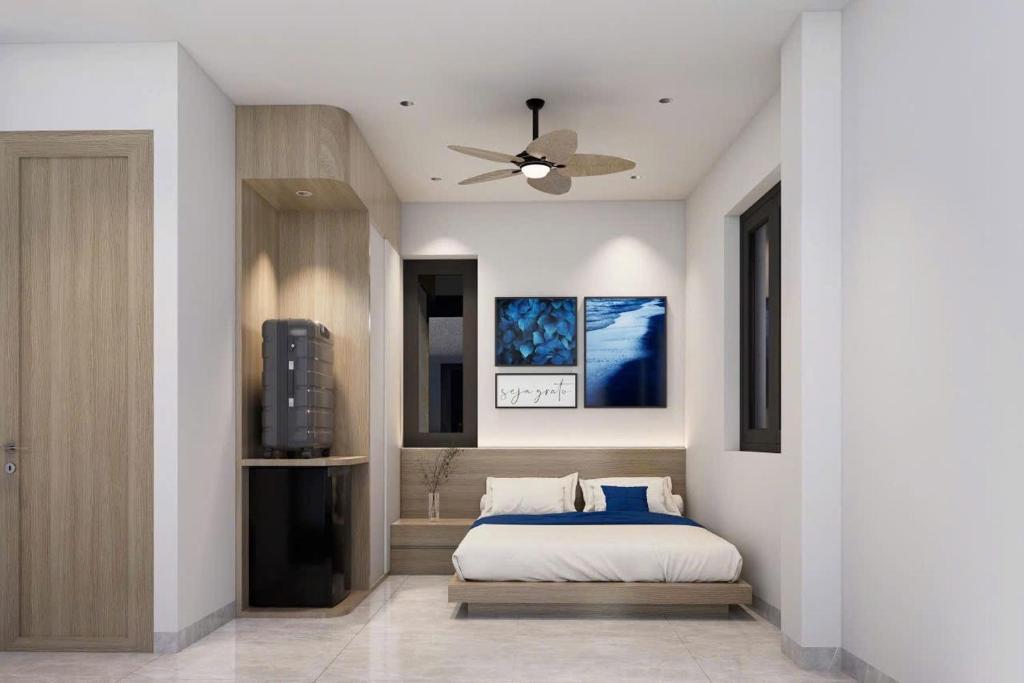 a bedroom with a bed and a ceiling fan at Sealand hotel & spa in Dong Hoi