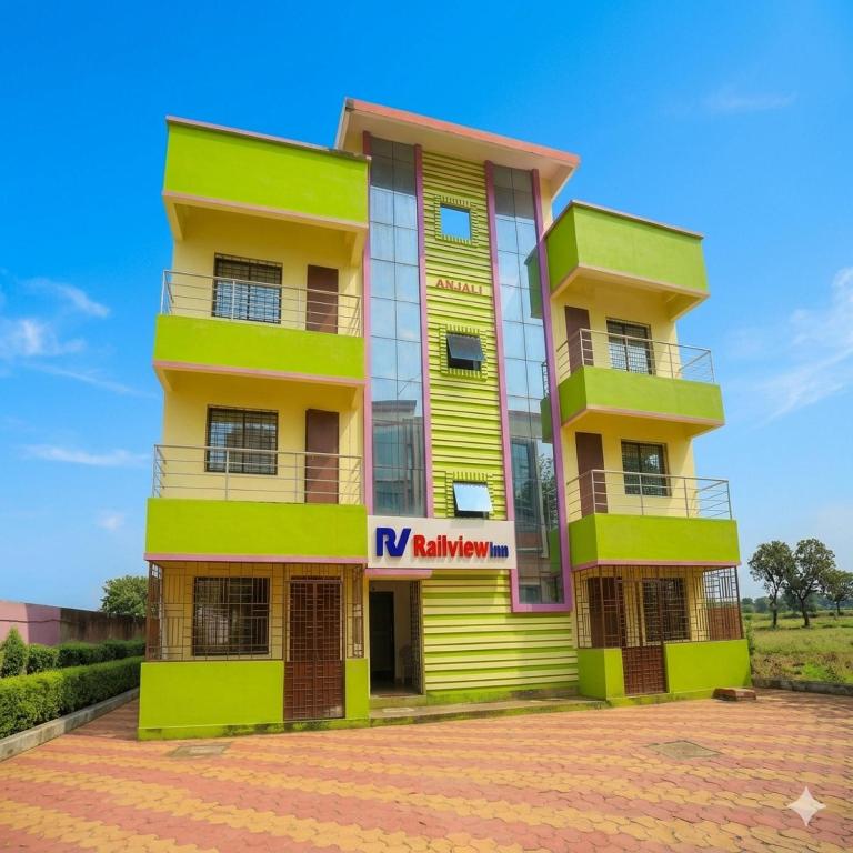 a building with yellow and green at Railview inn Bhubaneswar in Bhubaneshwar