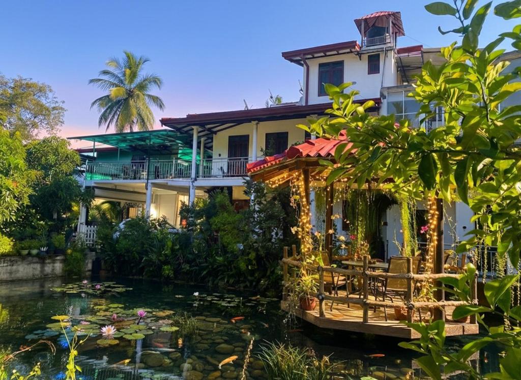 a house with a pond in front of a building at Haritha Villa Yala in Kirinda
