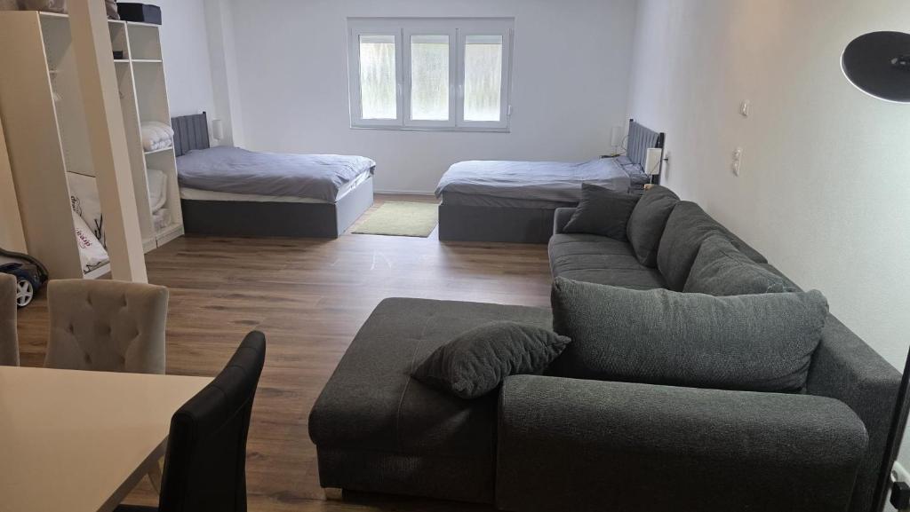 a living room with a couch and a bed at Spacious Apartment for 8 Guests in Tuttlingen