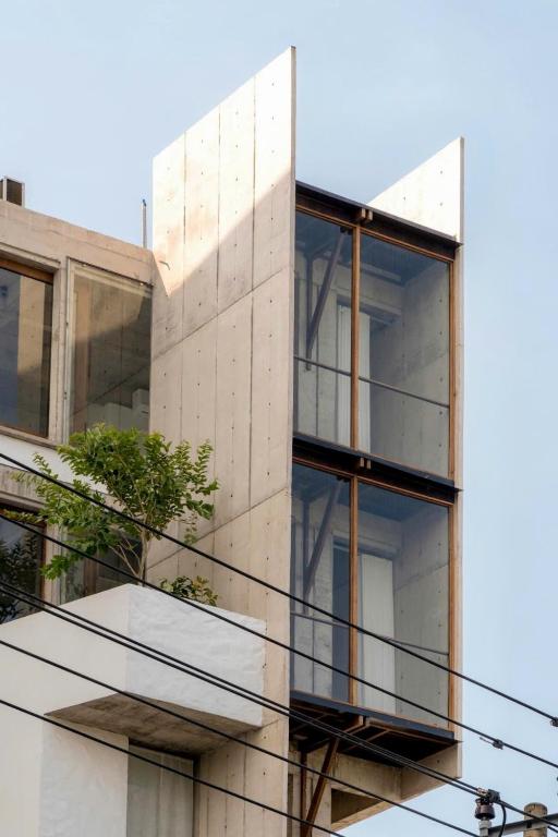 an external view of a building with glass balconies at The Still Slow & Sip in Nha Trang