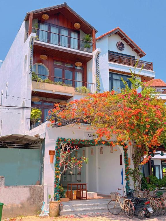 a building with a bunch of flowers on it at Anriva Hoi An in Hoi An