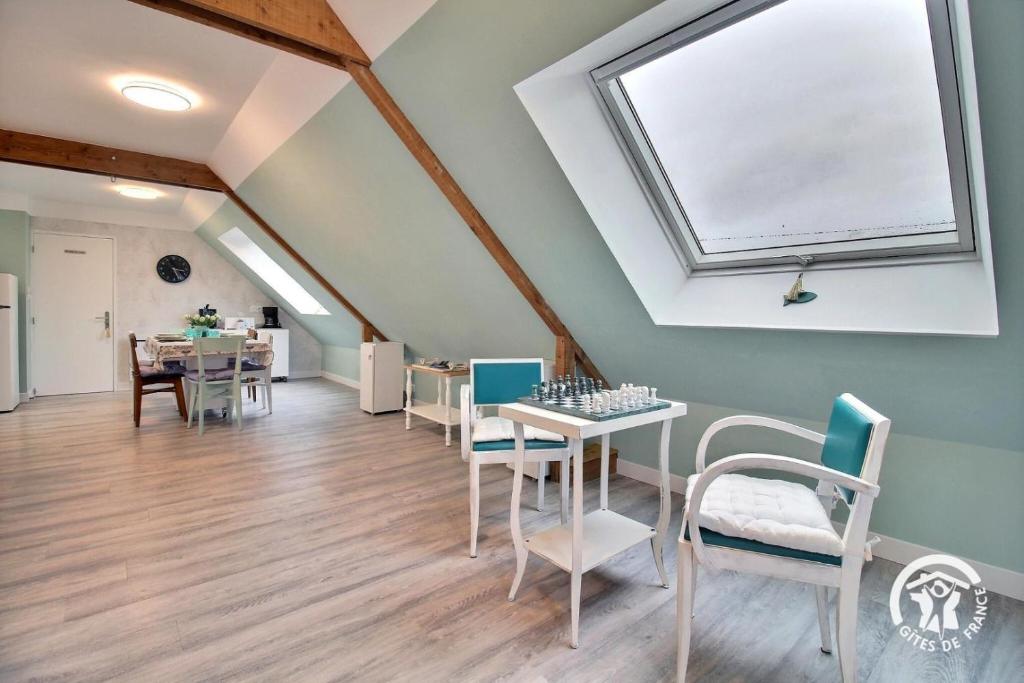 a room with a table and chairs and a window at De l'ar mor bihan in Riantec