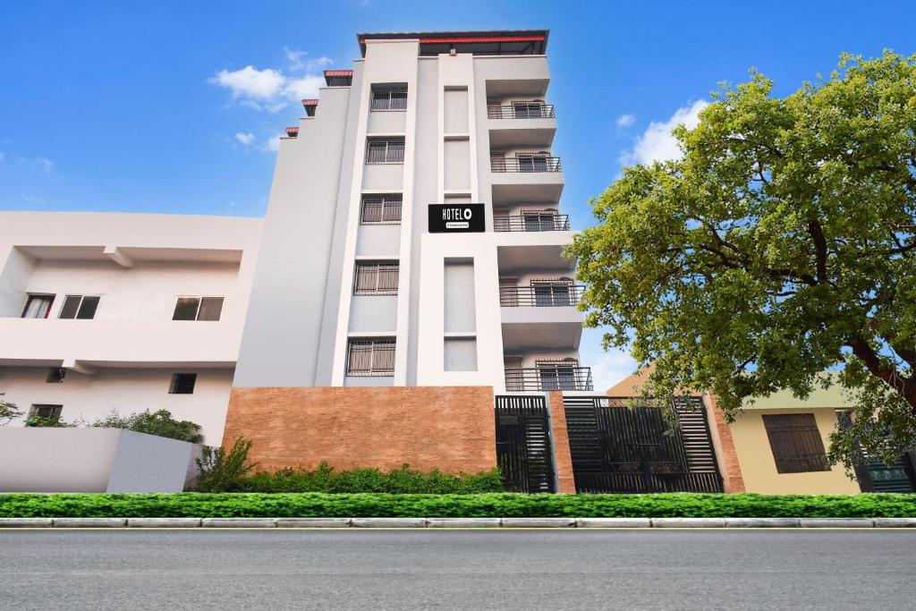 a white building with a sign in front of it at Hotel O Raipur City Center Formerly South Inn in Raipur