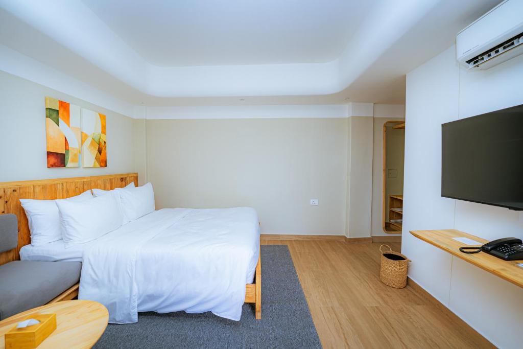 a hotel room with a bed and a flat screen tv at 31 Park Hotel in Pokhara