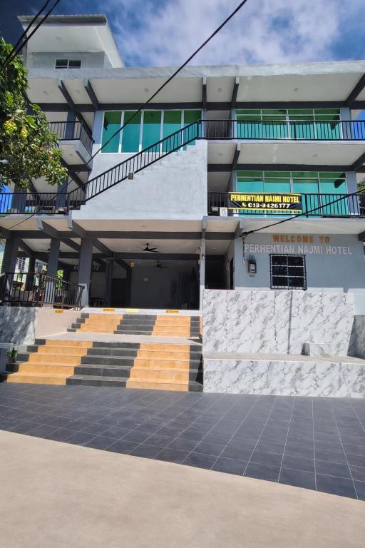 a building with stairs leading up to a building at Perhentian Najmi Hotel in Perhentian Islands